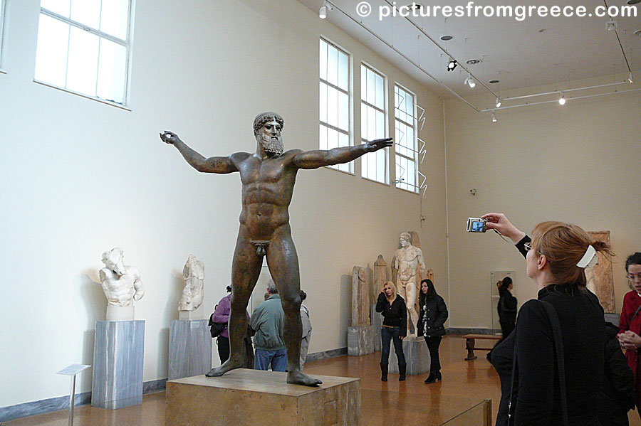 You find the bronze statue of either Zeus or Poseidon in the National Archaeological Museum of Athens.
